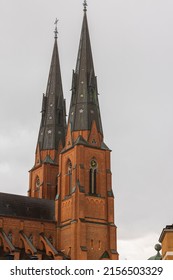 Beautiful close up view of top towers of Uppsala Cathedral Church on pale sky background. Sweden.