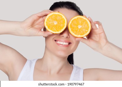 Beautiful Close-up Portrait Of Young Woman With Oranges. Healthy Food Concept. Skin Care And Beauty. Vitamins And Minerals.