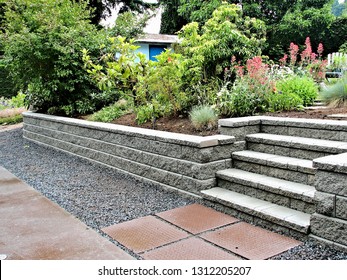 A beautiful closeup view of a staircase incorporated into a block retaining wall with steps leading into existing landscaped garden  - Shutterstock ID 1312205207
