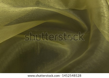 Beautiful closeup of yellow sateen fabric with textile texture background