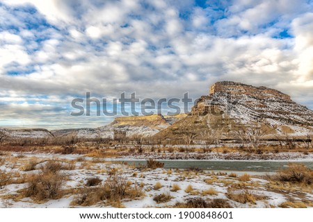 beautiful clouds roll over the desert buttes at Colorado State Park, James M. Robb Island acres state park on a winter day with the Colorado River running through it