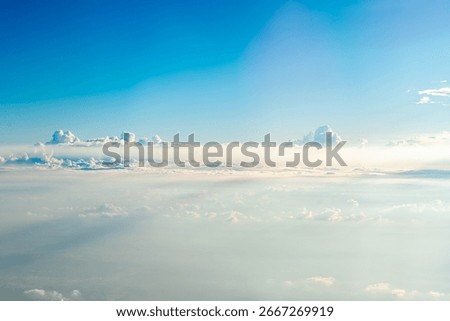 Beautiful cloudscape featuring a gradient blue sky and soft white clouds, creating a serene and peaceful atmosphere, perfect for backgrounds and travel themes