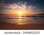 Beautiful cloudscape over the sea waves and sandy tropical beach, ocean coast sunrise