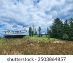 Beautiful cloudy skies of northern michigan. Boat nestled on the banks of lake Michigan. 