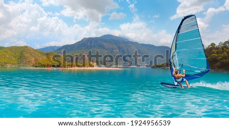 Beautiful cloudy sky with Windsurfer Surfing The Wind On Waves - Panoramic view of Oludeniz Beach And Blue Lagoon, Oludeniz beach is best beaches in Turkey - Fethiye, Turkey