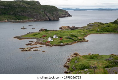 Beautiful coastal fishing town of Salvage, Newfoundland. On the northern part of the island. Several traditional wooden saltbox houses on a peninsula in the ocean. - Shutterstock ID 1998056753