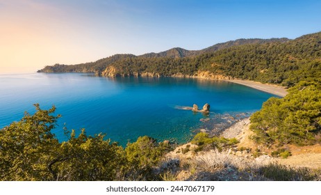 Beautiful coastline landscape with rocky cliffs, sandy beach, turquoise sea and vivid green vegetation on smooth hills, Lycian Way, Turkey - Powered by Shutterstock