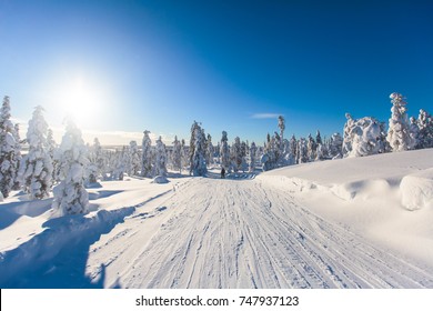 Beautiful cold mountain view of ski resort, sunny winter day with slope, piste and ski lift
