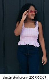 Beautiful Colombian Teen Standing In Front Of An Old Door