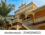 Beautiful colonial architecture in Luanda Angola showcasing intricate ironwork and vibrant colors under a clear blue sky