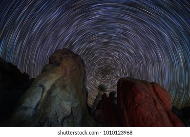 Beautiful Color Of Star Trails And Unique Shape Of Boulders In Big Bend National Park, Texas. Earth Spinning At Night. 