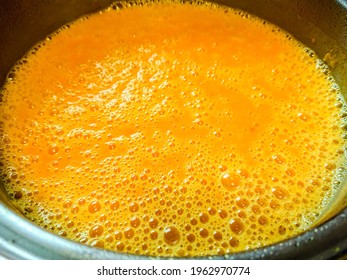 Beautiful colored cream pumpkin soup in pot, close up