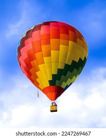 A beautiful colored hot air balloon on a hot summers day