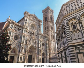 Beautiful colored marble facade of the famous cathedral or Cattedrale di Santa Maria del Fiore and Giotto's bell tower near Baptistery of St. John in the Piazza del Duomo. Florence, Tuscany, Italy. - Powered by Shutterstock