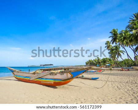 Beautiful Colorful Catamaran Boat on the White Sand Sandy Beach in Sri Lanka