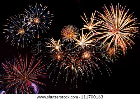 Beautiful colorful holiday fireworks on the black sky background,  long exposure