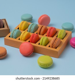 Beautiful colorful macarons. Colorful composition of different types of macaron cookies on a light blue background.