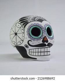 Beautiful and colorful Mexican skull isolated, made of ceramic, and painted by hand. Craft made in Mexico. White background. Traditional mexican skull for the Day of the Deads.
