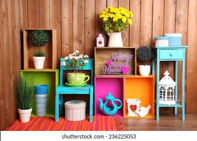 Beautiful colorful shelves with different home related objects on wooden wall background - Powered by Shutterstock