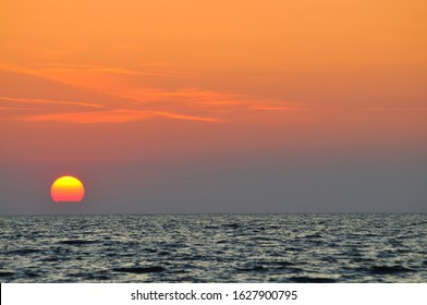 Beautiful colorful sunset over wavy waters of Black sea in Crimea on summer day. Natural landscape background and wallpaper
