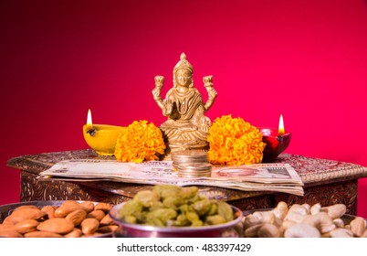 Beautiful Colourful Diya Or Clay Oil Lamp Lit  With Statue Of Goddess Laxmi On Lakshmi Pujan Or Pooja In Diwali Or Deepawali, A Festival Of Light