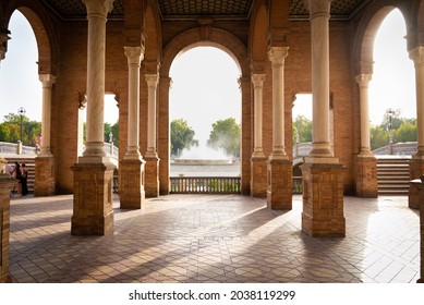 Beautiful columns and arches at the famous "Plaza de Espagna" (meaning: "Spain square) in Seville, Andalusia, Spain. Fountain with water in the background. - Shutterstock ID 2038119299