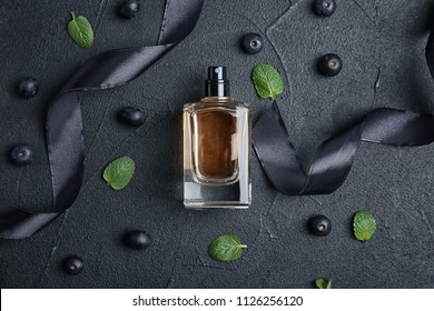 Beautiful composition with bottle of perfume on dark background, flat lay - Powered by Shutterstock