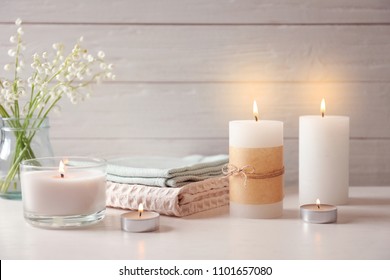 Beautiful composition with burning wax candles on table