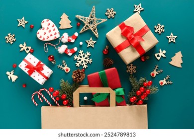 Beautiful composition with Christmas gifts, paper bag and wooden toys on blue background - Powered by Shutterstock