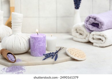 Beautiful composition with lavender sea salt, herbal bag and candle on tile background, closeup - Powered by Shutterstock