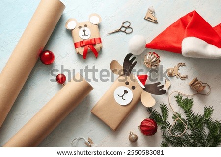 Beautiful composition with present boxes, Santa hat and Christmas toys on blue grunge background