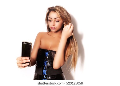 Beautiful And Conceited Woman Looking At Smartphone