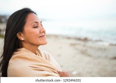 Beautiful confident Asian woman standing on the beach.