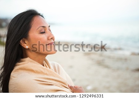 Beautiful confident Asian woman standing on the beach.