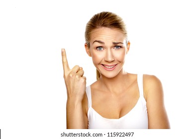 Beautiful confused woman with a raised eyebrow and quizzical expression pointing with her finger above her head isolated on white