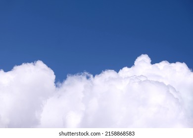 Beautiful contrast sky landscape with white clouds on the bottom of photo and gradient blue sky above on bright sunny day horizontal view