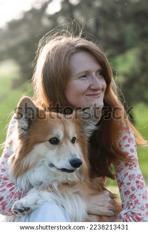 beautiful corgi dog and girl on the lawn in the park
