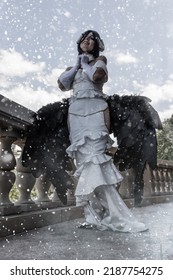 A Beautiful Cosplay Woman With Angel Costume With Black Wings In The Snowfall