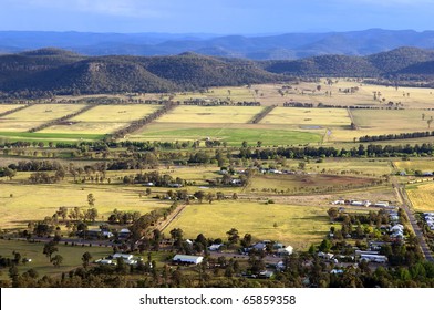 Beautiful Country Area With Small Town And Brightly Colored Fields