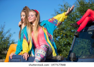 Beautiful Country Girls Dressed In The Style Of The Nineties Sit On A Tractor.