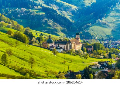 Beautiful countryside mountain landscape with a monastery in village. Germany, Black forest, Muenstertal. Toned - Powered by Shutterstock