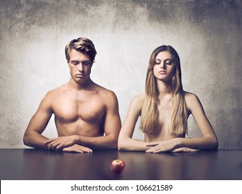 Beautiful couple with apple in front of them