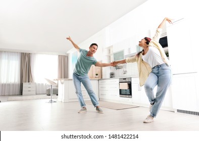 Beautiful Couple Dancing In Kitchen At Home