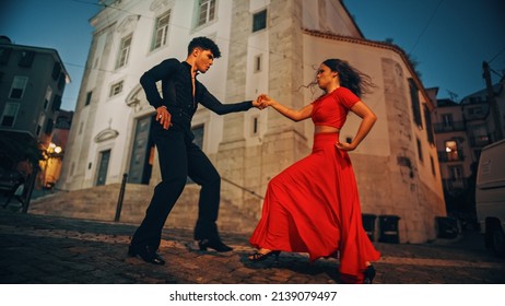 Beautiful Couple Dancing A Latin Dance On The Quiet Street Of An Old Town In A City. Sensual Dance By Two Professional Dancers In The Evening In Ancient Culturally Rich Tourist Location.