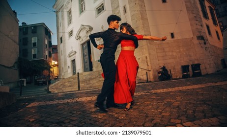 Beautiful Couple Dancing A Latin Dance On The Quiet Street Of An Old Town In A City. Sensual Dance By Two Professional Dancers In The Evening In Ancient Culturally Rich Tourist Location.