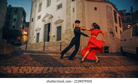 Beautiful Couple Dancing A Latin Dance On The Quiet Street Of An Old Town In A City. Sensual Dance By Two Professional Dancers In The Evening In Ancient Culturally Rich Tourist Location.