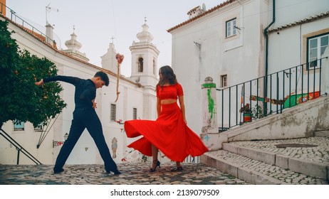 Beautiful Couple Dancing A Latin Dance On The Quiet Street Of An Old Town In A City. Sensual Dance By Two Professional Dancers On A Sunny Day Outside In Ancient Culturally Rich Tourist Location.