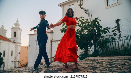 Beautiful Couple Dancing A Latin Dance On The Quiet Street Of An Old Town In A City. Sensual Dance By Two Professional Dancers On A Sunny Day Outside In Ancient Culturally Rich Tourist Location.