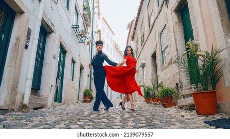 Beautiful Couple Dancing A Latin Dance On The Quiet Street Of An Old Town In A City. Sensual Dance By Two Professional Dancers On A Sunny Day Outside In Ancient Culturally Rich Tourist Location.