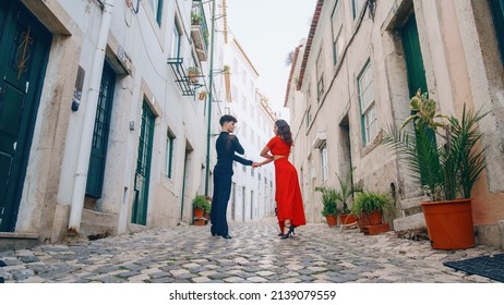 Beautiful Couple Dancing A Latin Dance On The Quiet Street Of An Old Town In A City. Sensual Dance By Two Professional Dancers On A Sunny Day Outside In Ancient Culturally Rich Tourist Location.